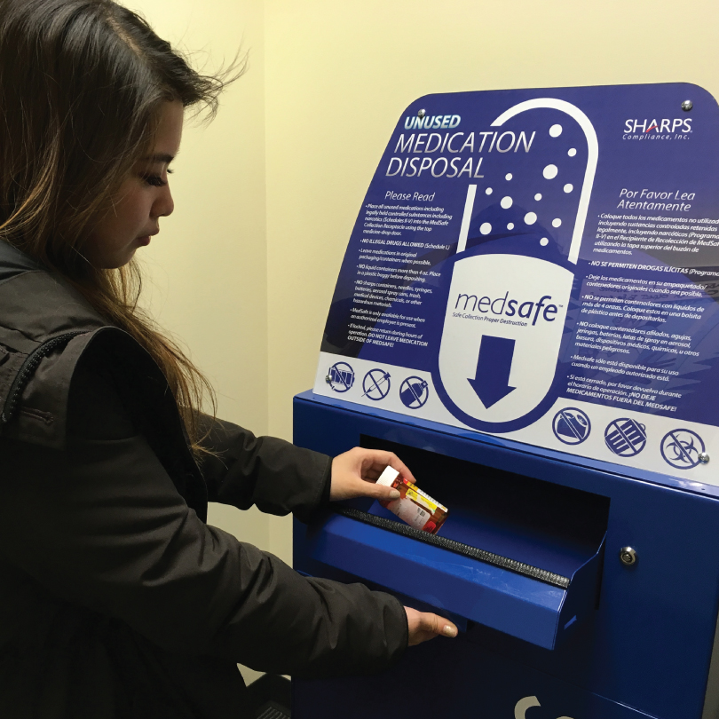 person putting medication into the medsafe receptacle